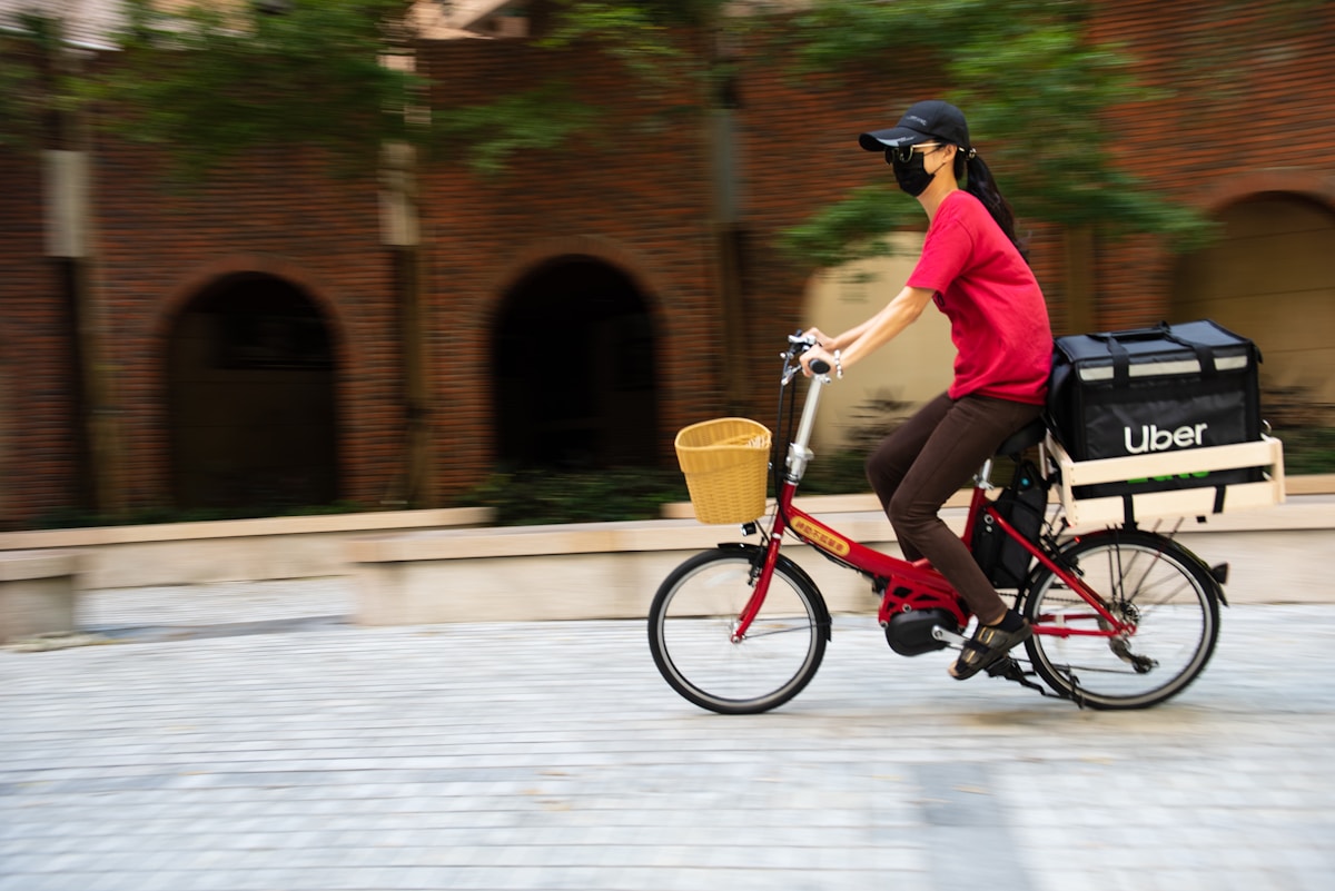 Uber Eats delivery person smiling with food delivery